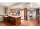 Open concept kitchen with breakfast bar, wood cabinets, and stainless steel appliances at 5037 N 81St St, Scottsdale, AZ 85250