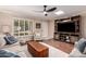 Inviting living room featuring a ceiling fan, built-in entertainment center and shuttered window at 5037 N 81St St, Scottsdale, AZ 85250