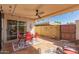 Outdoor patio area with red table, chairs, ceiling fan, and string lights at 5037 N 81St St, Scottsdale, AZ 85250