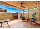 Relaxing outdoor patio with a ceiling fan, bistro seating, string lights, and decorative cacti at 5037 N 81St St, Scottsdale, AZ 85250