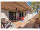 Covered outdoor patio area with red furniture, ceiling fan, and outdoor rug at 5037 N 81St St, Scottsdale, AZ 85250