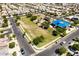 Aerial view of a vibrant community park with play structures, shaded seating, and landscaped areas for Gathering activities at 5518 S Dillon Cir, Mesa, AZ 85212