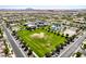 An aerial view of a common area of a neighborhood with a large grassy field at 5518 S Dillon Cir, Mesa, AZ 85212