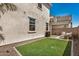 Backyard featuring artificial grass, a patio area, and privacy with surrounding fencing for outdoor enjoyment at 5518 S Dillon Cir, Mesa, AZ 85212