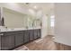 Bathroom with double sink vanity with granite countertop, wood-look tile floor, and ample lighting at 5518 S Dillon Cir, Mesa, AZ 85212