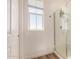 Modern bathroom features a glass-enclosed shower with a window and a white door at 5518 S Dillon Cir, Mesa, AZ 85212