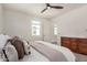 Comfortable bedroom includes ceiling fan, picture window, carpet, and a wooden dresser at 5518 S Dillon Cir, Mesa, AZ 85212