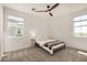 Bright bedroom featuring plush carpet, a modern ceiling fan, and light-filled windows with scenic neighborhood views at 5518 S Dillon Cir, Mesa, AZ 85212