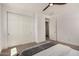 This bedroom features carpet, a ceiling fan, and a large closet with sliding doors at 5518 S Dillon Cir, Mesa, AZ 85212