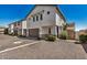 Townhome row features attached garages, neutral color schemes, tidy landscaping, and private entrances at 5518 S Dillon Cir, Mesa, AZ 85212