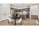 Modern eat-in kitchen with gray cabinets, a center island, and stainless steel appliances at 5518 S Dillon Cir, Mesa, AZ 85212