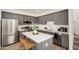 Modern kitchen features gray cabinets, stainless steel appliances, and a center island with seating at 5518 S Dillon Cir, Mesa, AZ 85212