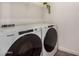 Laundry room with modern, front-load Whirlpool washer and dryer, plus a shelf for storage at 5518 S Dillon Cir, Mesa, AZ 85212