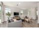 Bright living room with stylish gray sofa, modern furniture, and plenty of natural light at 5518 S Dillon Cir, Mesa, AZ 85212