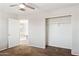 Bright bedroom with neutral colors, carpet floors and closet, adjoining hall with open door at 5553 W Minton Ave, Laveen, AZ 85339