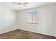 This spacious bedroom features neutral tones, a ceiling fan, and a window letting in natural light at 5553 W Minton Ave, Laveen, AZ 85339