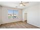 Bedroom featuring a ceiling fan, a view of the neighborhood, and a walk-in closet at 5553 W Minton Ave, Laveen, AZ 85339
