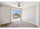Bright bedroom with a sliding door leading to a deck, neutral paint, and modern ceiling fan at 5553 W Minton Ave, Laveen, AZ 85339