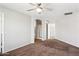 Bright bedroom with neutral carpeting, a ceiling fan, and an ensuite bathroom at 5553 W Minton Ave, Laveen, AZ 85339