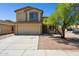 Charming two-story home featuring a two-car garage, neutral color palette, and a well-manicured front yard with mature tree at 5553 W Minton Ave, Laveen, AZ 85339