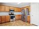 Well-equipped kitchen featuring stainless steel appliances, wood cabinets and tile floors at 5553 W Minton Ave, Laveen, AZ 85339