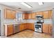 Modern kitchen with stainless steel appliances, wood cabinets, tile floors and ample counter space at 5553 W Minton Ave, Laveen, AZ 85339