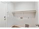 A simple laundry room featuring tile flooring and a utility shelf at 5553 W Minton Ave, Laveen, AZ 85339