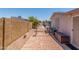 Paver backyard featuring a red brick wall, landscaping, and storage at 5735 E Mcdowell Rd # 464, Mesa, AZ 85215
