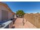 Paver backyard featuring a red brick wall, landscaping, and clear sky at 5735 E Mcdowell Rd # 464, Mesa, AZ 85215