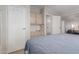 Well-lit bedroom with built-in storage, closet space, and connecting door to living space at 5735 E Mcdowell Rd # 464, Mesa, AZ 85215