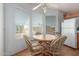 Cozy dining area with a round wooden table, surrounded by windows, offering natural light at 5735 E Mcdowell Rd # 464, Mesa, AZ 85215