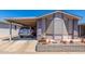 Charming single-story home featuring a covered carport and beautifully landscaped front yard at 5735 E Mcdowell Rd # 464, Mesa, AZ 85215
