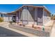 Charming single-story home featuring a covered carport and beautifully landscaped front yard at 5735 E Mcdowell Rd # 464, Mesa, AZ 85215