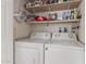 Functional laundry room with washer, dryer and shelving for ample storage at 5735 E Mcdowell Rd # 464, Mesa, AZ 85215