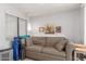 Cozy living room featuring a comfortable couch, window with blinds, and simple decor at 5735 E Mcdowell Rd # 464, Mesa, AZ 85215