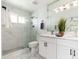 Modern bathroom with a glass-enclosed shower, dual sinks, and marble accents at 6127 N 16Th Pl, Phoenix, AZ 85016