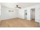 Bright bedroom with hardwood floors, ceiling fan, and access to a modern bathroom and walk-in closet at 6127 N 16Th Pl, Phoenix, AZ 85016
