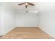 Bright bedroom featuring hardwood floors, white walls, and a ceiling fan at 6127 N 16Th Pl, Phoenix, AZ 85016