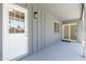 Covered patio features a glass sliding door, a white door, and a light fixture at 6127 N 16Th Pl, Phoenix, AZ 85016