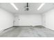 Spacious two-car garage with bright lighting, white walls, and an automatic door at 6127 N 16Th Pl, Phoenix, AZ 85016