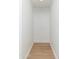 Hallway with hardwood floors, base molding, and painted white walls at 6127 N 16Th Pl, Phoenix, AZ 85016