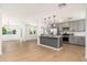 Open concept kitchen with gray cabinets, stainless steel appliances, and a view into the living room at 6127 N 16Th Pl, Phoenix, AZ 85016