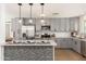 Modern kitchen with gray cabinets, stainless steel appliances, and quartz countertops at 6127 N 16Th Pl, Phoenix, AZ 85016