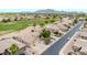 An aerial view displaying golf course community, mountain views and single-Gathering home exteriors at 6141 S Bradshaw Way, Chandler, AZ 85249