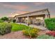 Inviting covered patio with green grass and lovely landscaping at sunset at 6141 S Bradshaw Way, Chandler, AZ 85249