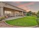 A covered patio provides a comfortable space to relax and enjoy the manicured lawn and landscaped garden at 6141 S Bradshaw Way, Chandler, AZ 85249