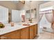 Bright bathroom with a large mirror, vanity, and view into an adjacent bath and shower area at 6141 S Bradshaw Way, Chandler, AZ 85249