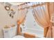 Bathroom features a shower with curtain, towel and shelving with decorative items at 6141 S Bradshaw Way, Chandler, AZ 85249