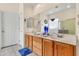 Well-lit bathroom with double sinks, wood cabinets, and ample counter space at 6141 S Bradshaw Way, Chandler, AZ 85249