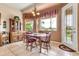 Inviting dining room with large windows, a charming chandelier, and classic wood furniture at 6141 S Bradshaw Way, Chandler, AZ 85249